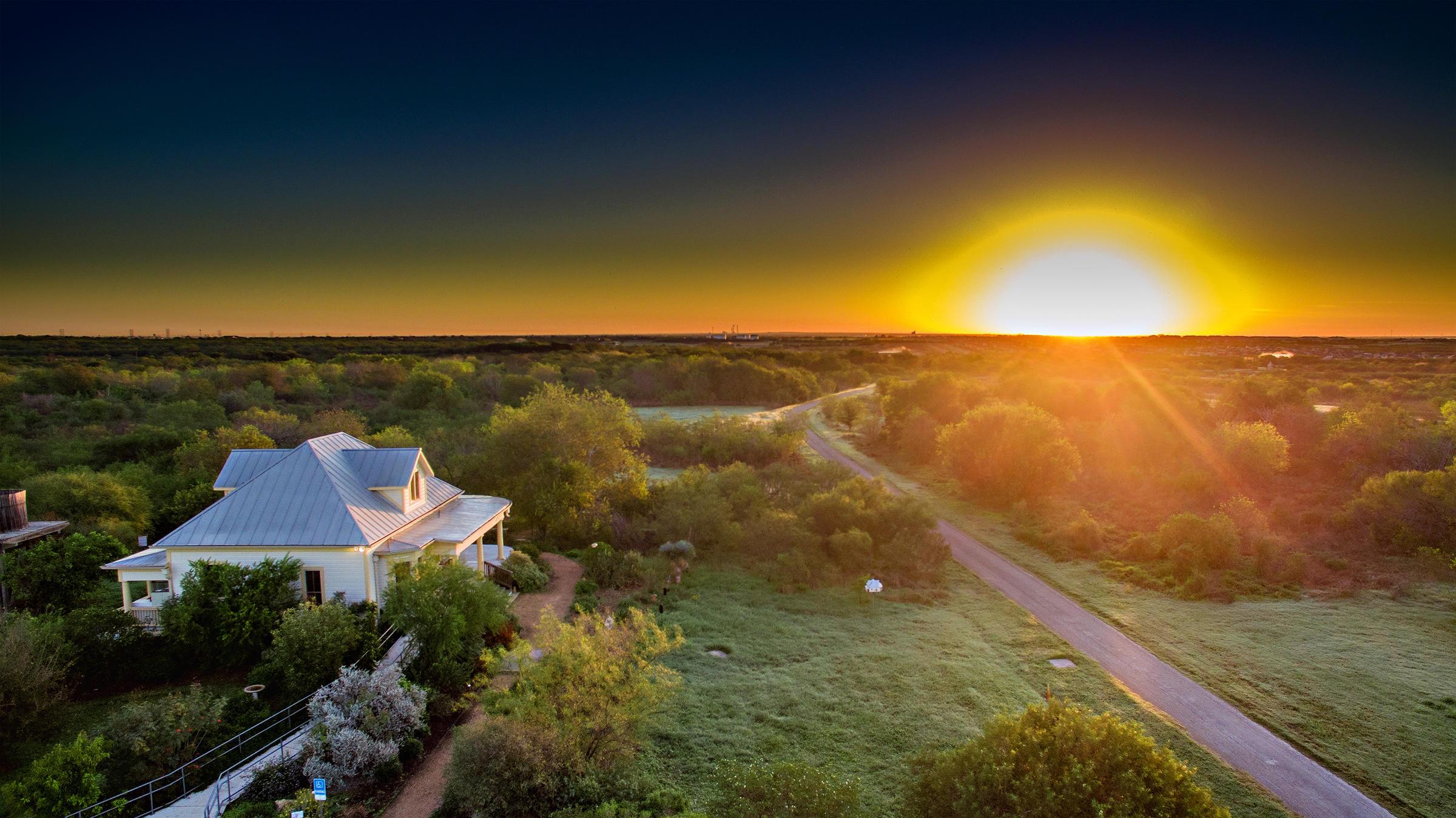 Aerial view of Mitchell Lake Audubon Center and the Leeper House at sunset