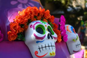 Decorative Día de los Muertos calavera skulls surrounded by colorful flowers at La Villita