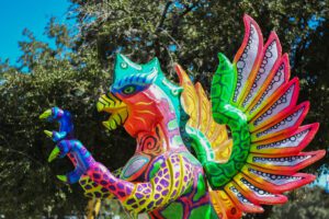 Brightly painted winged alebrije sculpture at La Villita in San Antonio
